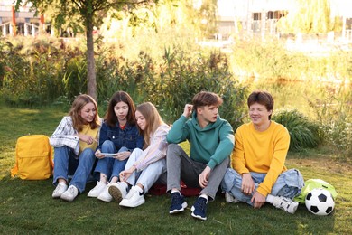 Photo of Group of teenagers spending time together in park