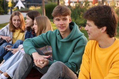 Photo of Group of teenagers spending time together in park
