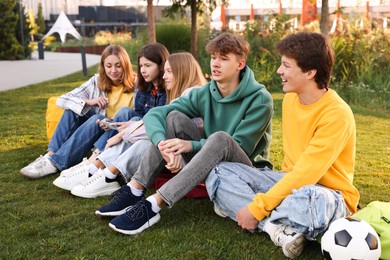 Photo of Group of teenagers spending time together in park
