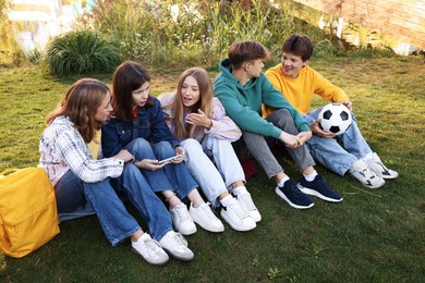 Photo of Group of teenagers spending time together in park