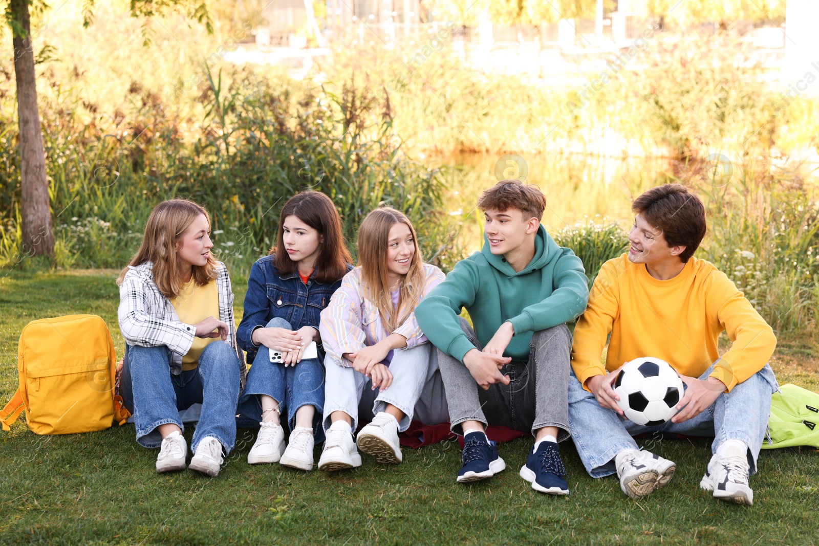 Photo of Group of teenagers spending time together in park