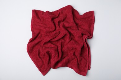 Photo of Red terry towel on light grey background, top view