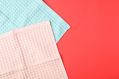 Photo of Clean waffle towels on red background, top view. Space for text