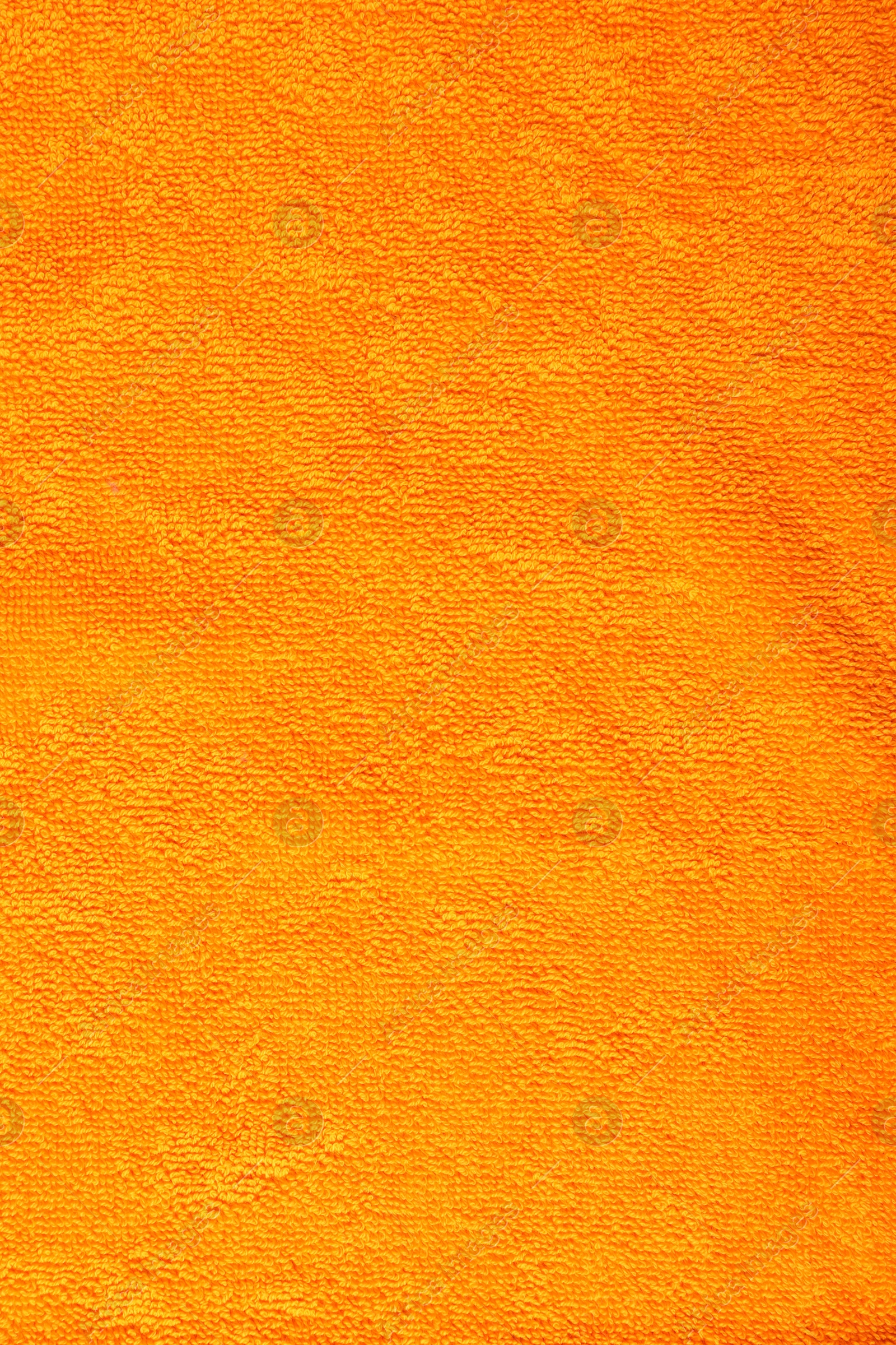 Photo of Orange terry towel as background, top view