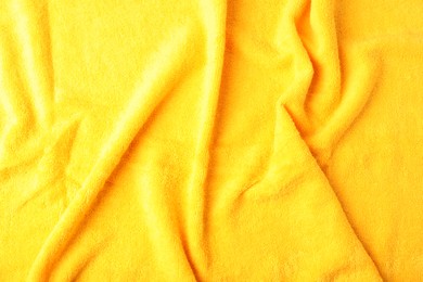 Photo of Yellow terry towel as background, top view