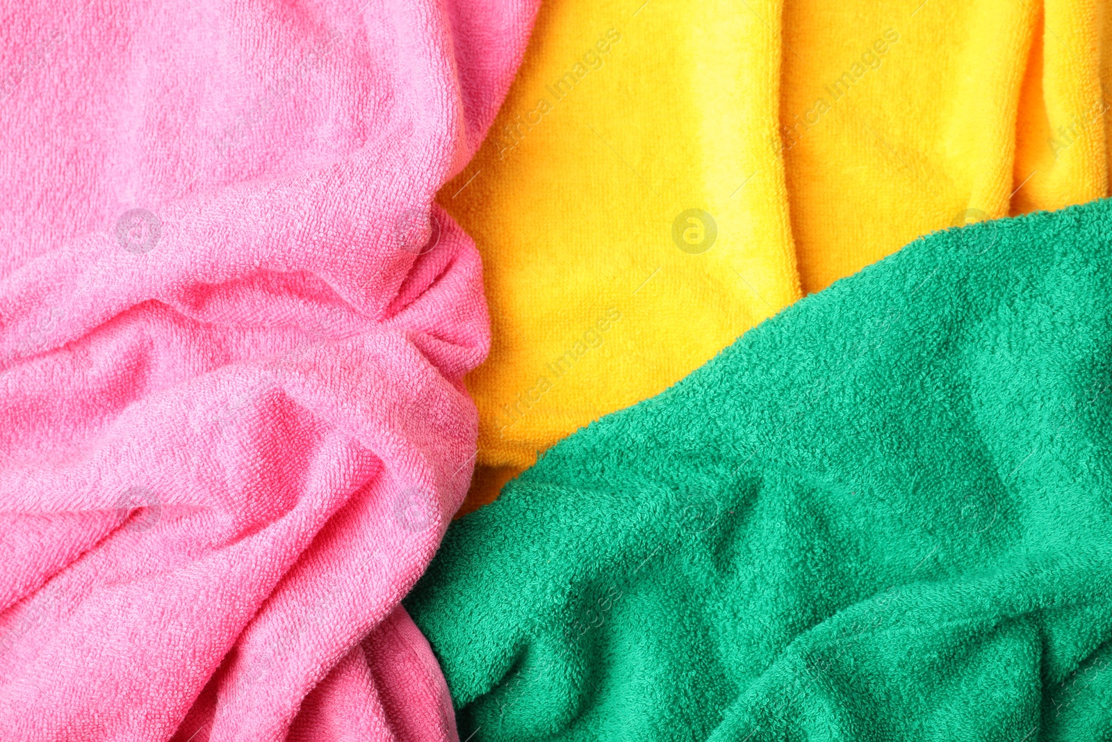 Photo of Bright terry towels as background, top view