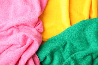 Photo of Bright terry towels as background, top view