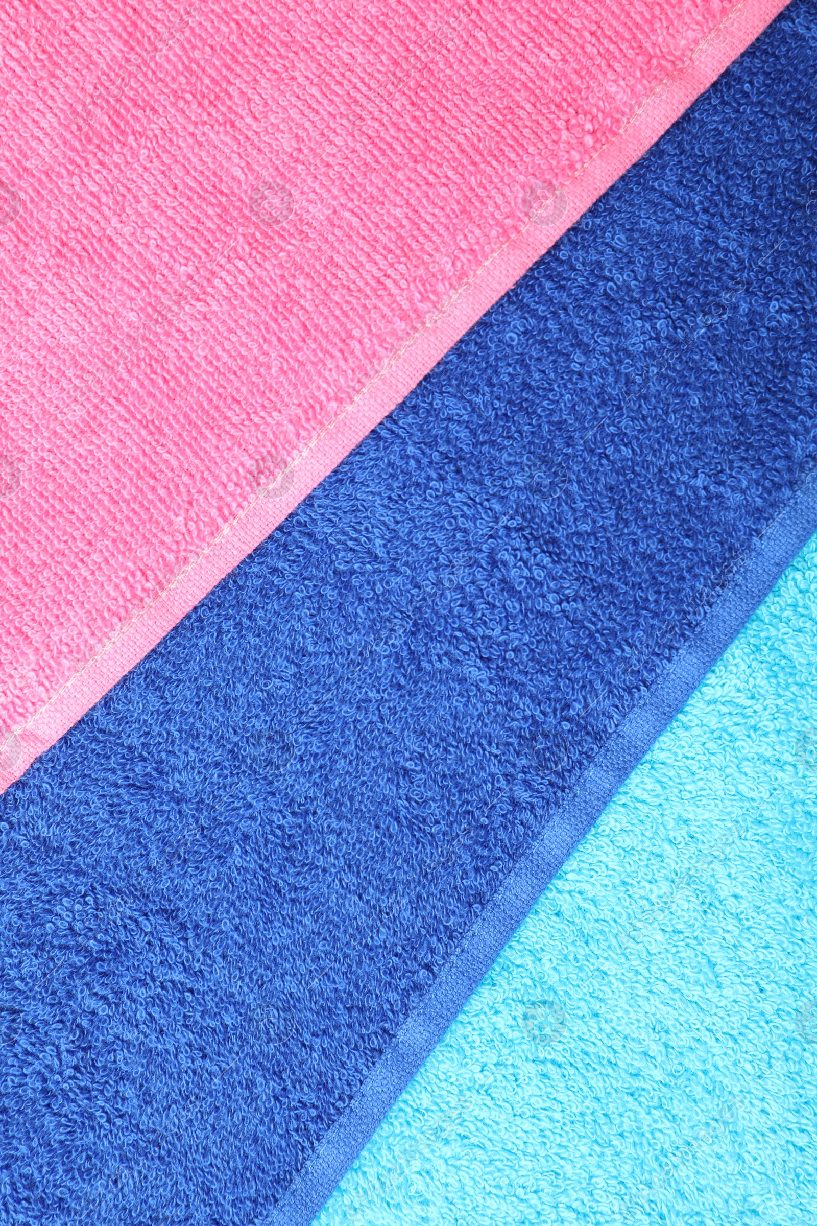 Photo of Bright terry towels as background, top view
