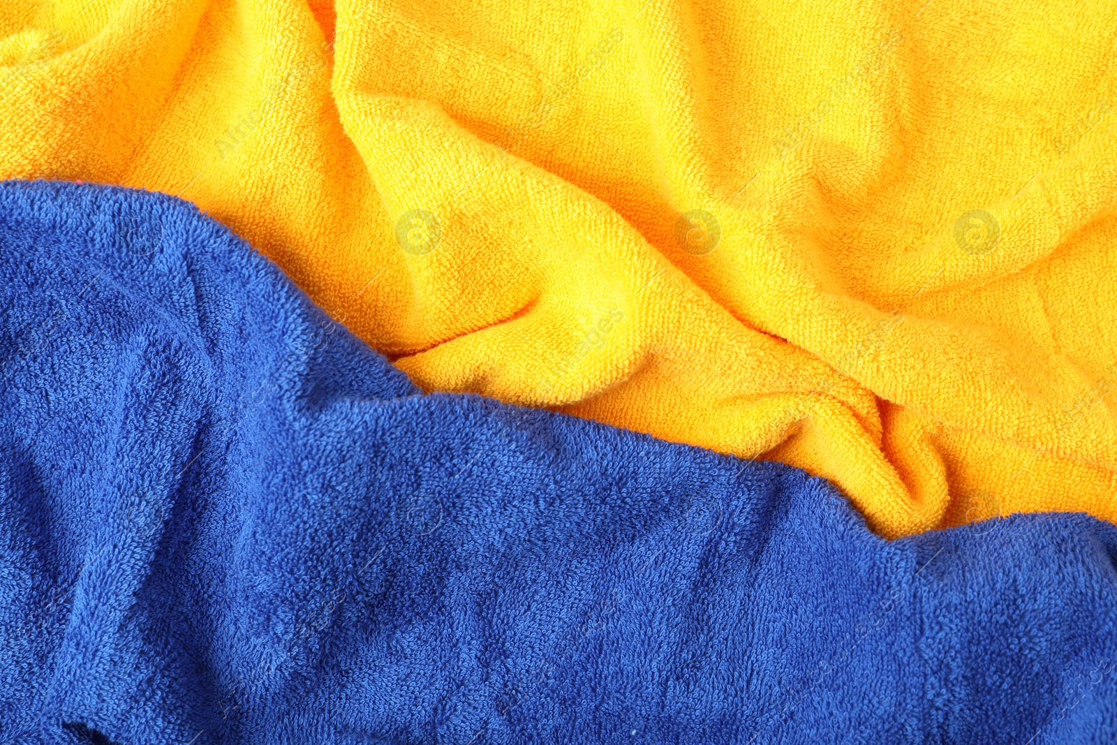 Photo of Bright terry towels as background, top view