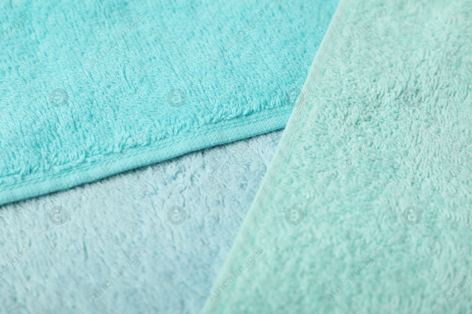 Photo of Light blue terry towels as background, closeup