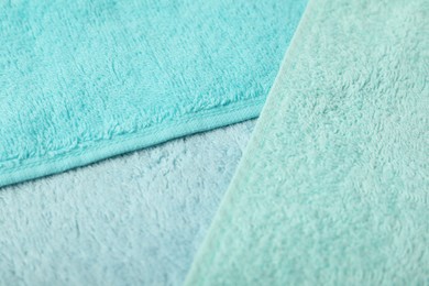 Photo of Light blue terry towels as background, closeup