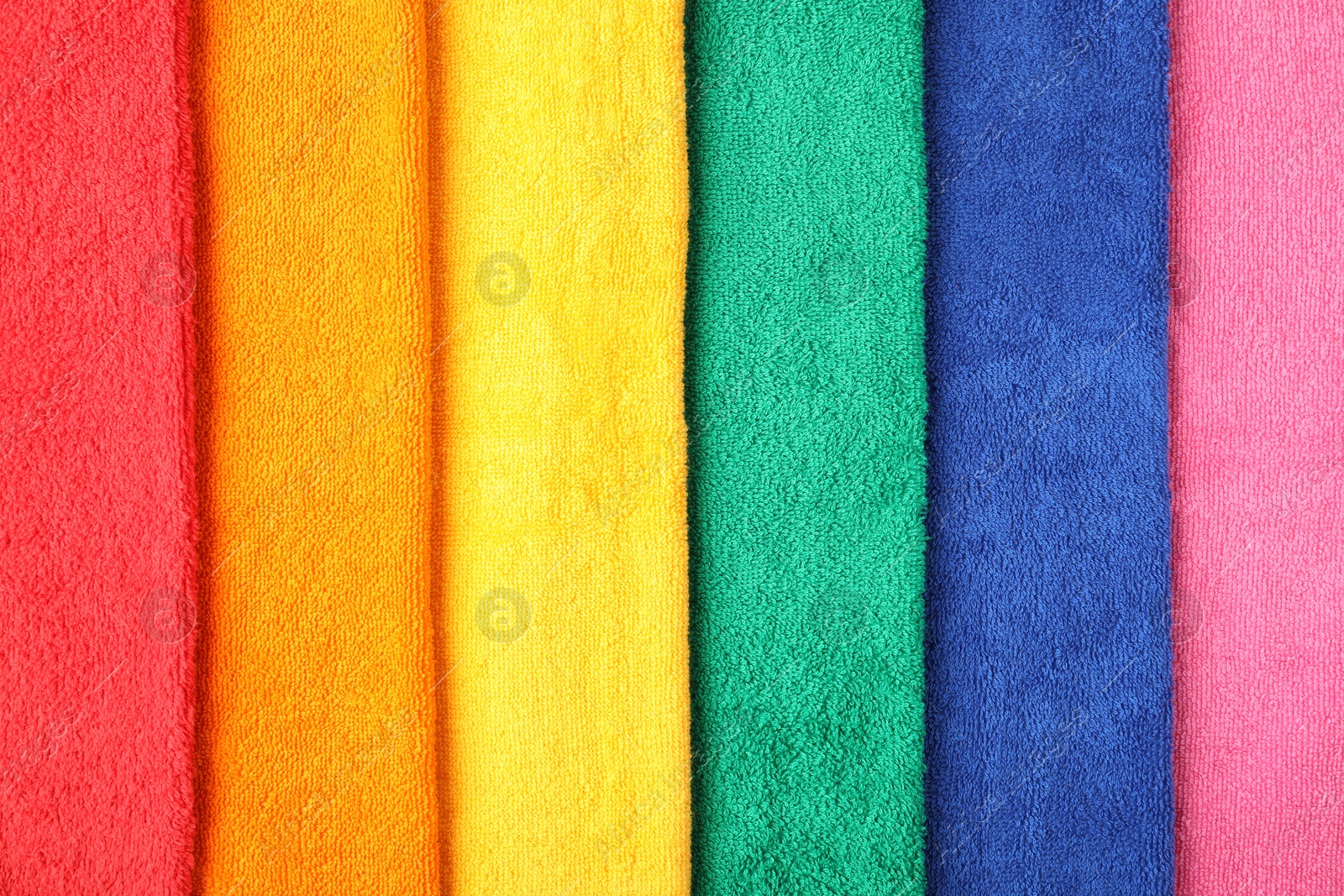 Photo of Bright terry towels as background, top view
