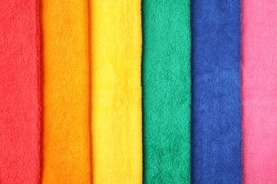 Photo of Bright terry towels as background, top view