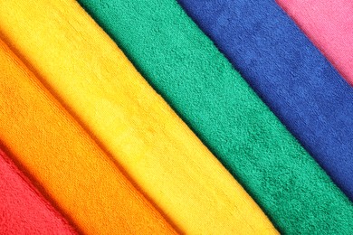 Photo of Bright terry towels as background, top view