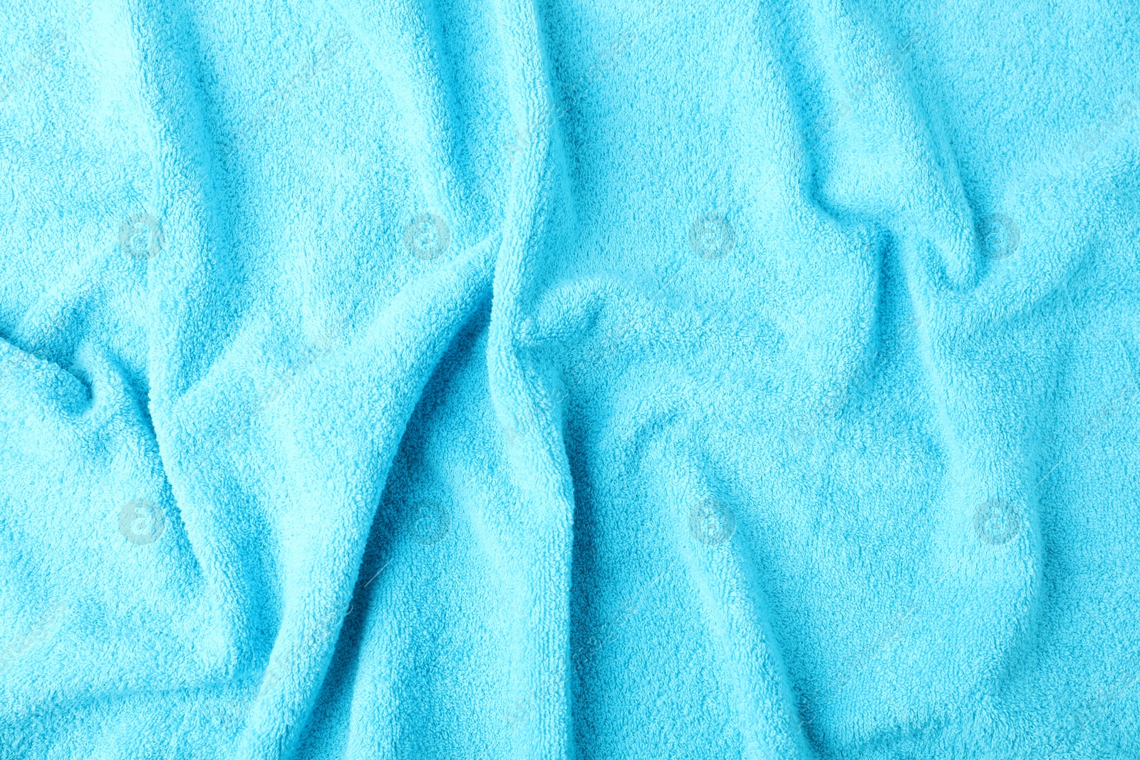 Photo of Light blue terry towel as background, top view
