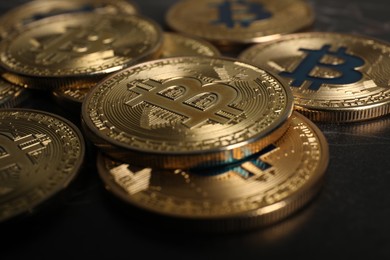 Photo of Cryptocurrency. Bitcoins on black table, closeup view