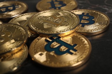 Photo of Cryptocurrency. Bitcoins on black table, closeup view