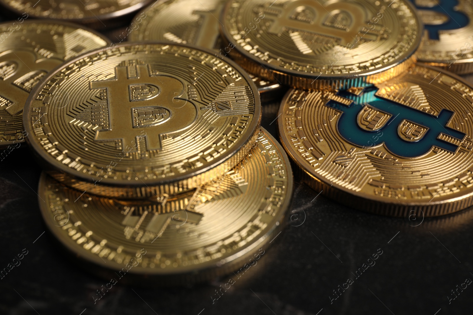 Photo of Cryptocurrency. Bitcoins on black table, closeup view