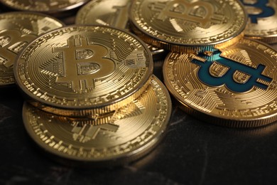 Photo of Cryptocurrency. Bitcoins on black table, closeup view
