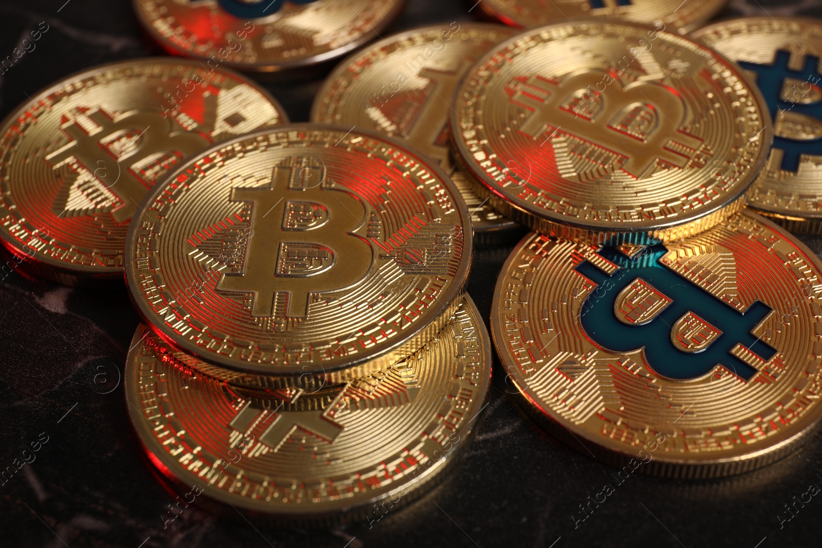 Photo of Cryptocurrency. Bitcoins on black table, closeup view