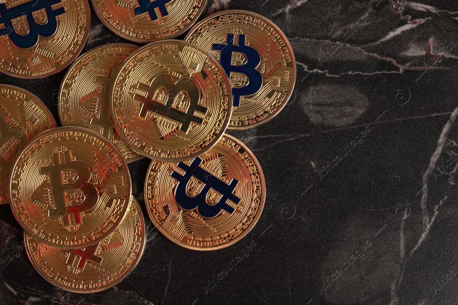 Photo of Cryptocurrency. Bitcoins on black table, flat lay