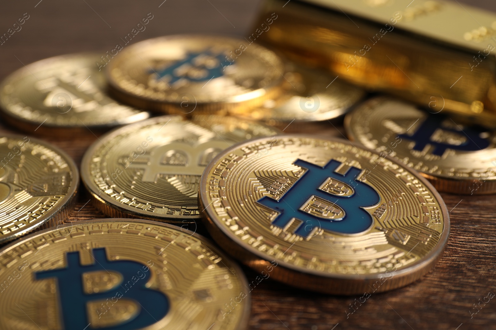 Photo of Cryptocurrency. Bitcoins on wooden table, closeup view