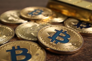 Photo of Cryptocurrency. Bitcoins on wooden table, closeup view