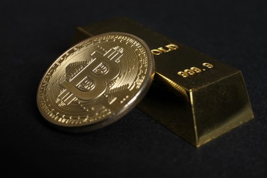 Photo of Bitcoin and gold bar on black background, closeup