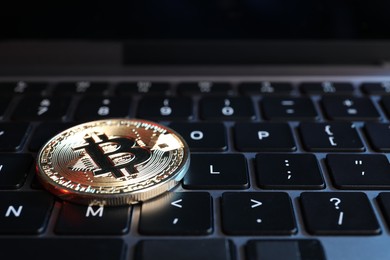 Photo of Cryptocurrency. Bitcoin on laptop keyboard, closeup view