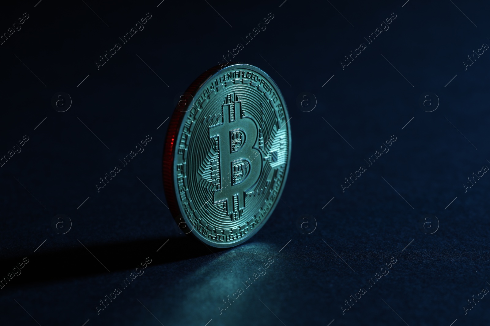Photo of Cryptocurrency. Bitcoin on blue background, closeup view