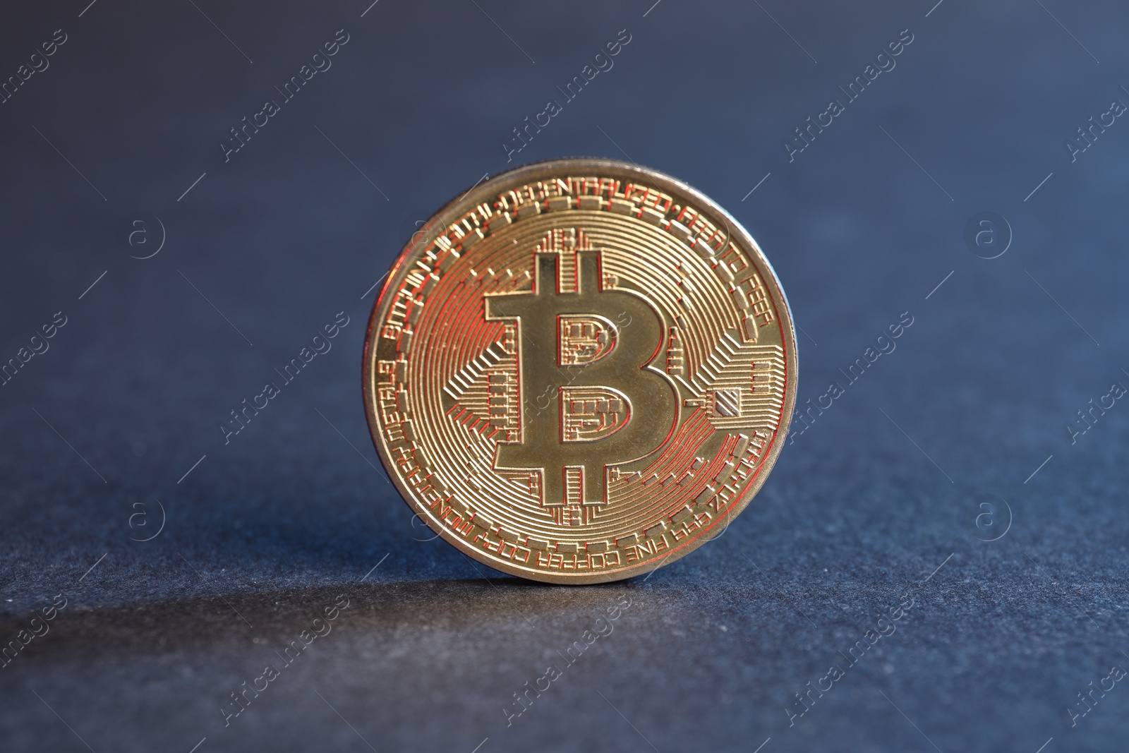 Photo of Cryptocurrency. Bitcoin on blue background, closeup view