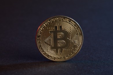 Photo of Cryptocurrency. Bitcoin on blue background, closeup view