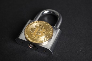 Photo of Bitcoin and padlock on grey background, closeup