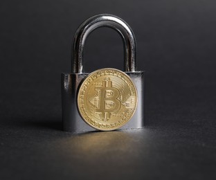 Photo of Bitcoin and padlock on grey background, closeup