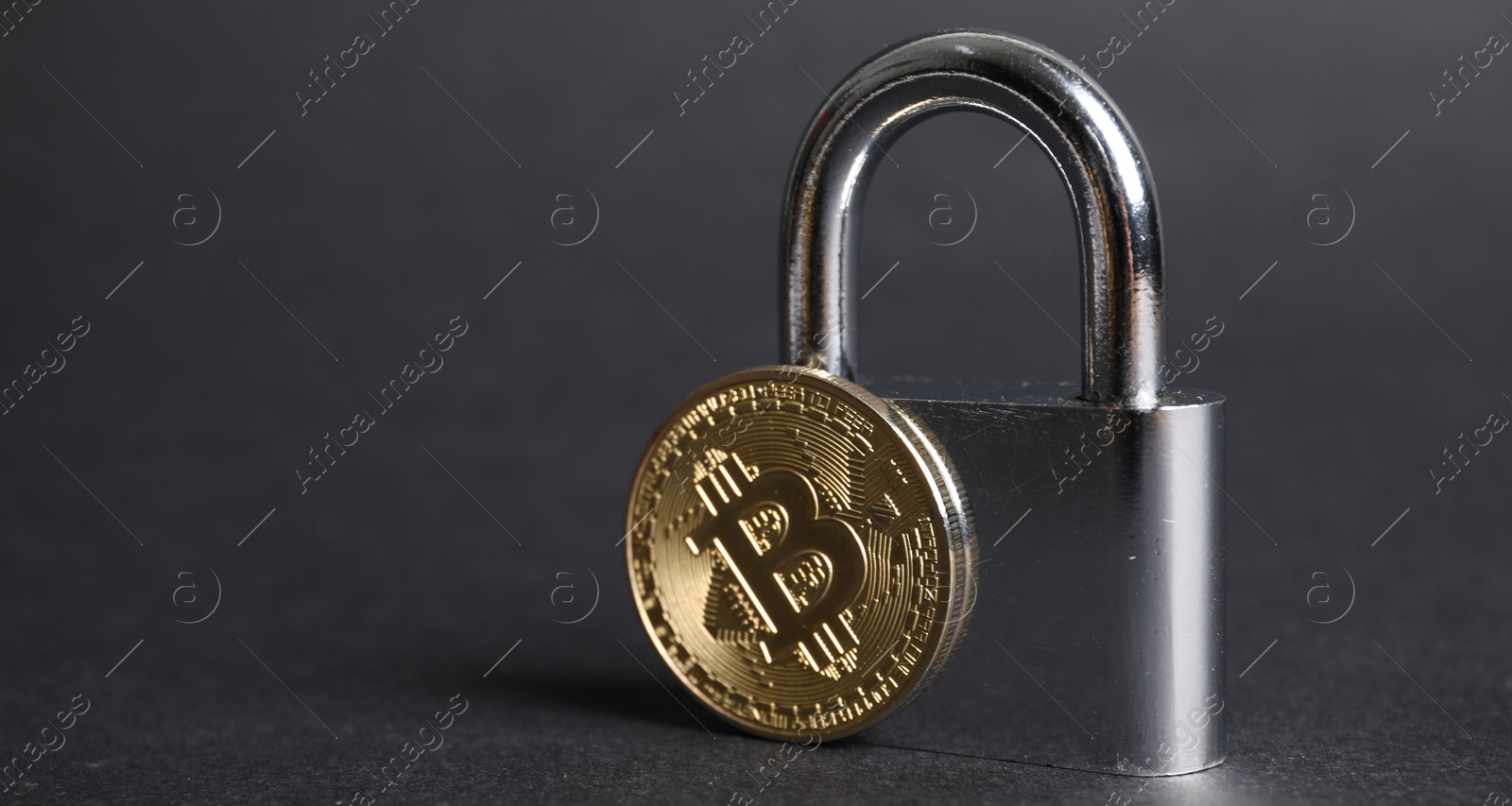 Photo of Bitcoin and padlock on grey background, closeup. Space for text