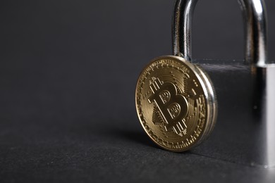 Photo of Bitcoin and padlock on grey background, closeup. Space for text