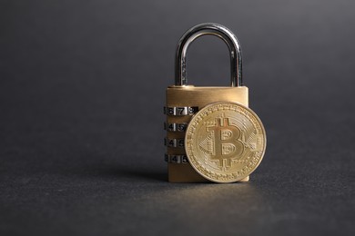 Photo of Bitcoin and padlock on grey background, closeup. Space for text