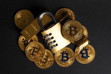 Photo of Bitcoins, padlock and gold bars on black background, top view