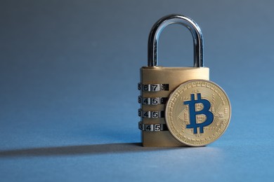 Photo of Bitcoin and padlock on color background, closeup. Space for text