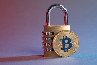 Photo of Bitcoin and padlock on color background, closeup. Space for text