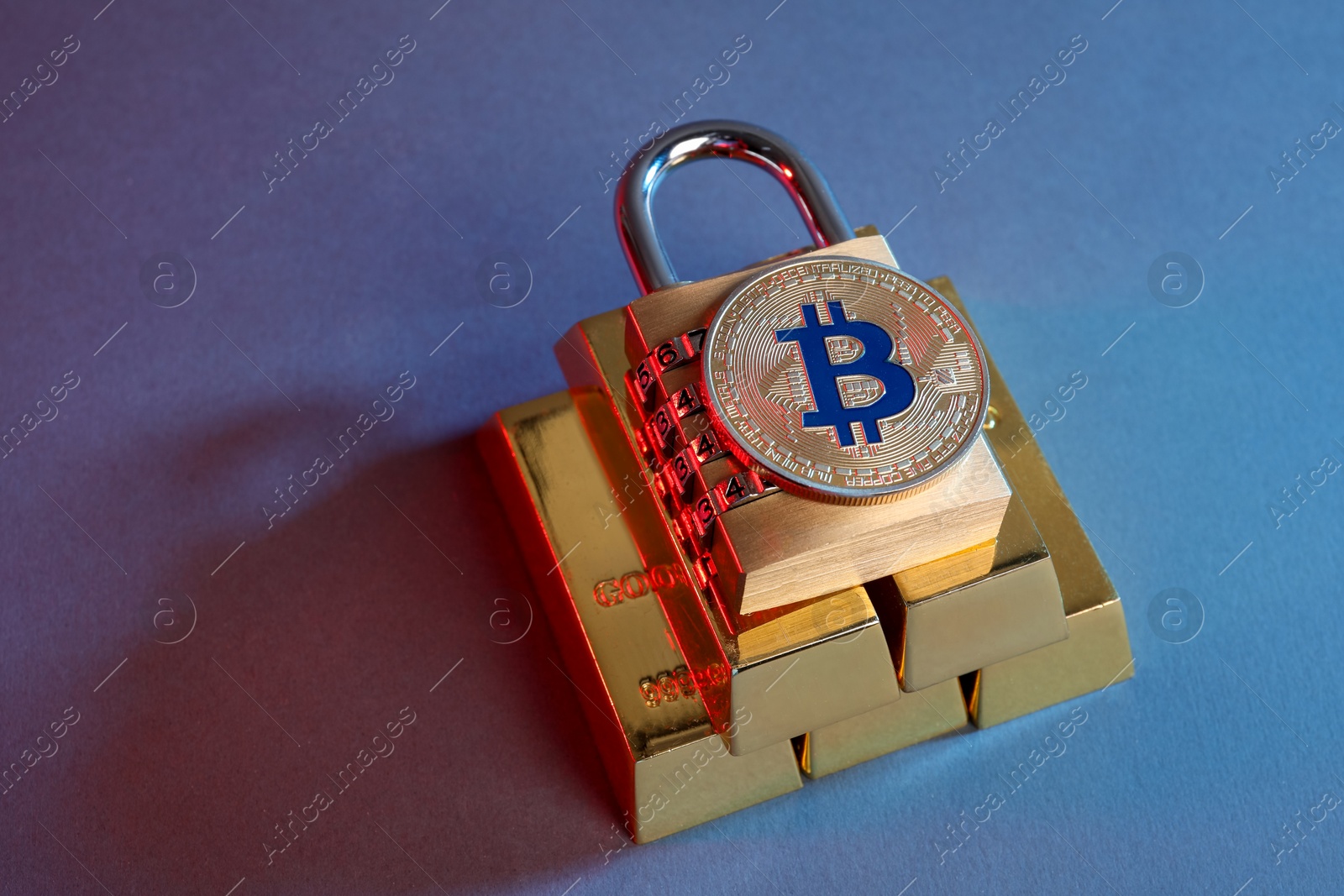 Photo of Bitcoin, padlock and gold bars on color background in red light, closeup