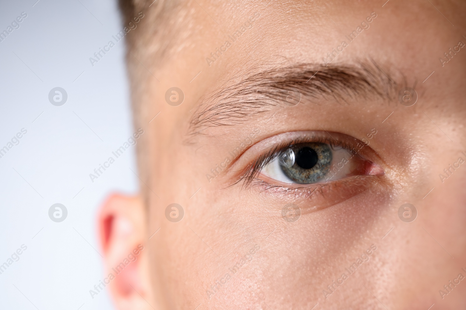Photo of Man with beautiful eyes on light grey background, closeup