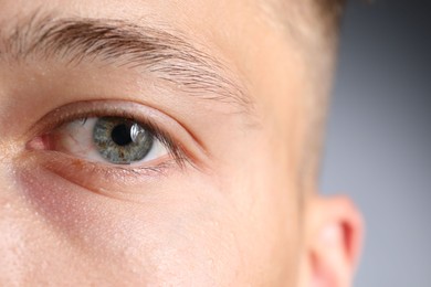 Photo of Man with beautiful eyes on light grey background, closeup