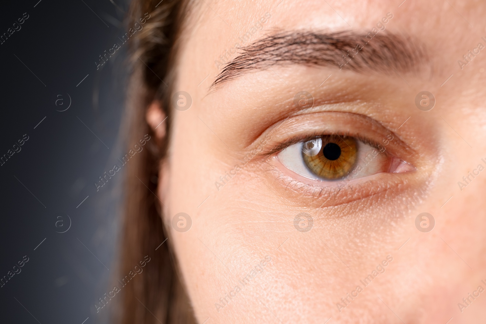 Photo of Woman with beautiful eyes on grey background, closeup