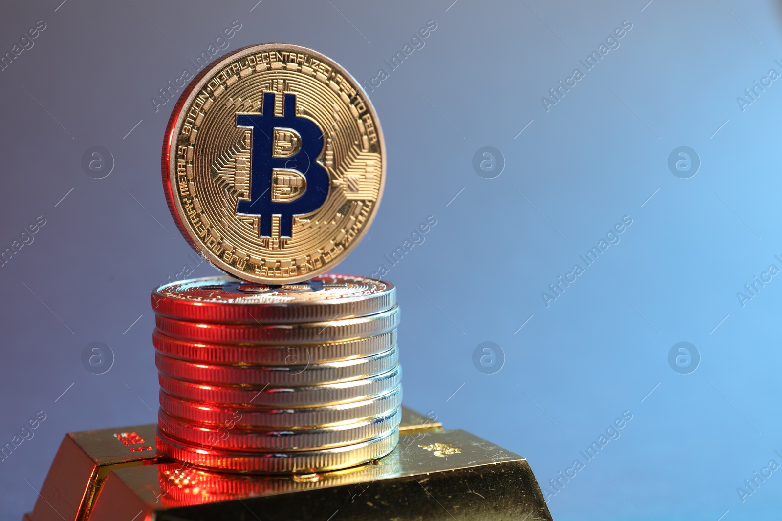 Photo of Bitcoins and gold bars on color background in red light, closeup. Space for text