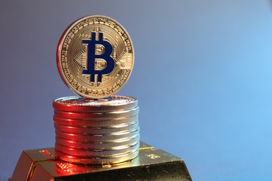 Photo of Bitcoins and gold bars on color background in red light, closeup. Space for text
