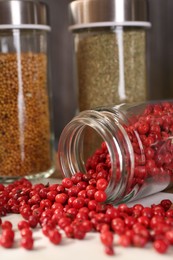 Photo of Different spices and glass jars on board, closeup