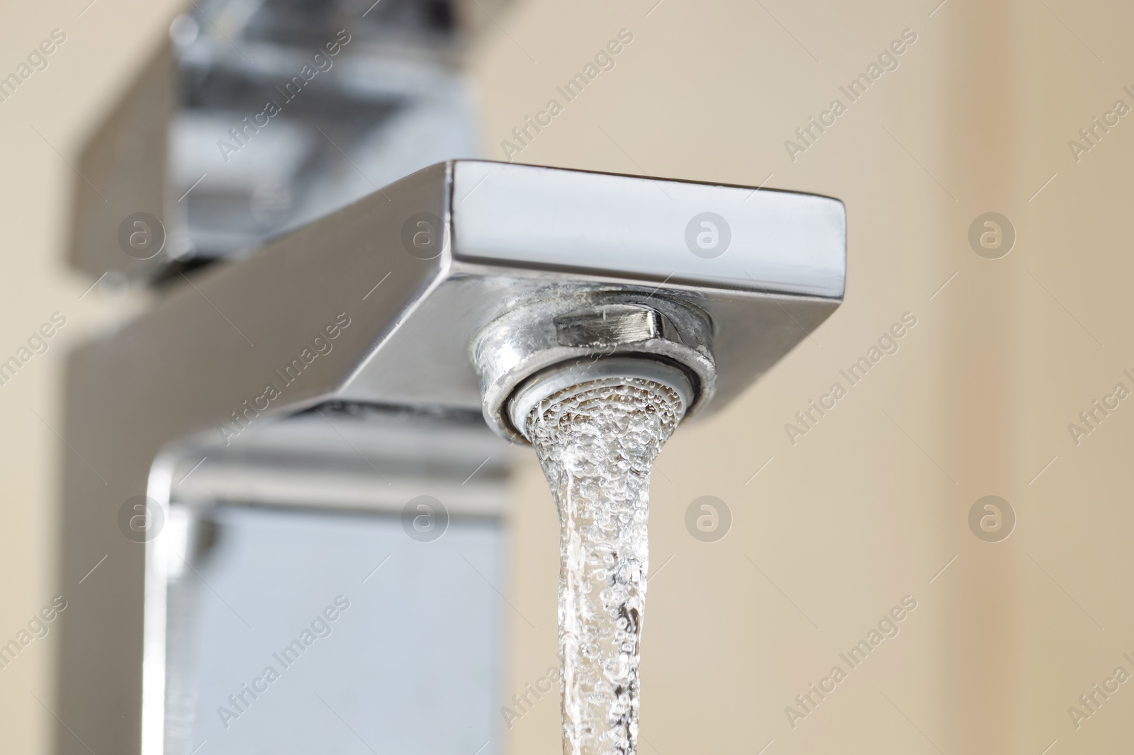 Photo of Water saving concept. Stream of water flowing from tap indoors, low angle view