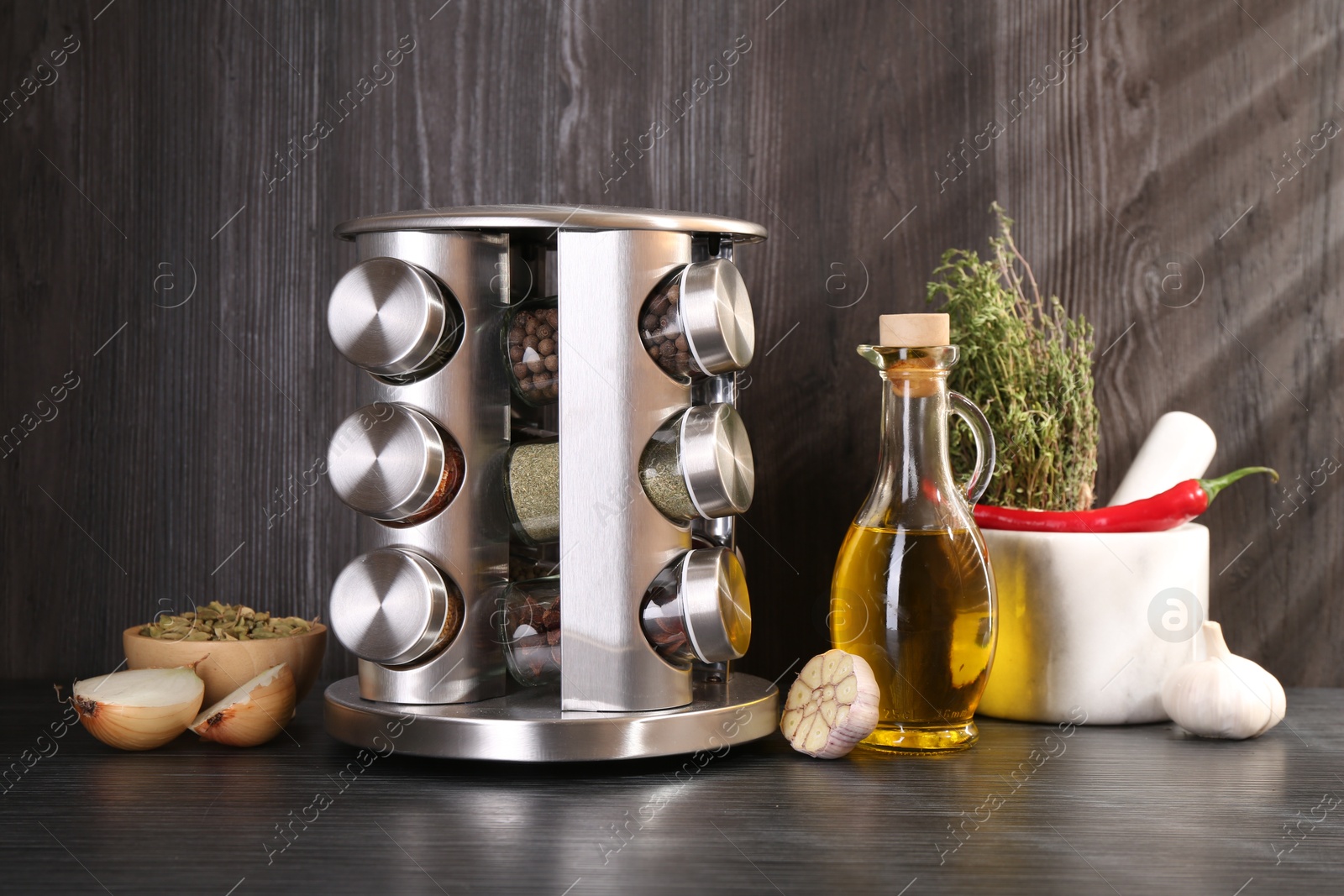 Photo of Set of jars with different spices on grey wooden table