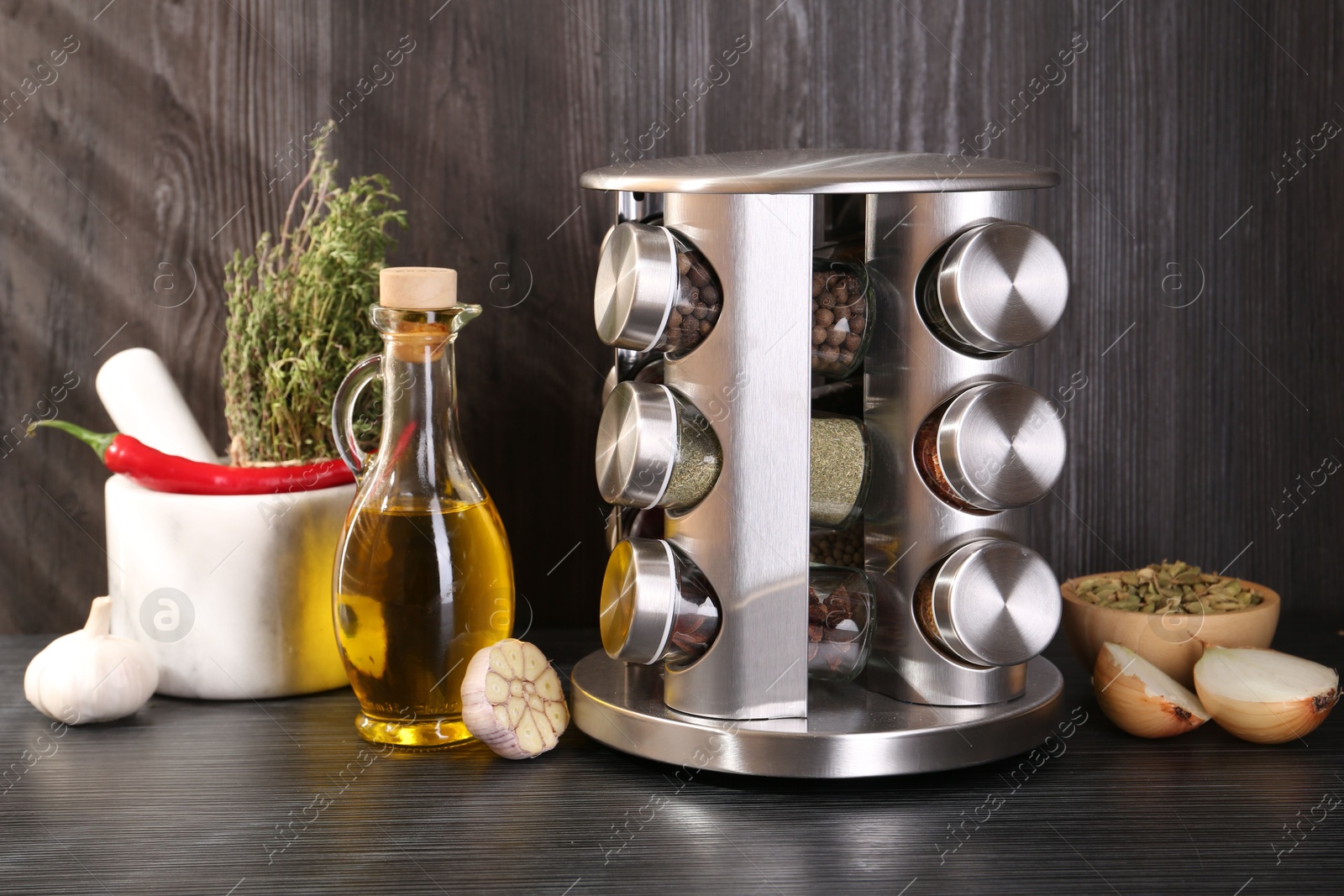 Photo of Set of jars with different spices on grey wooden table